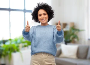 Happy woman giving thumbs up after seeing success with proven hair regrowth treatments in Brevard County